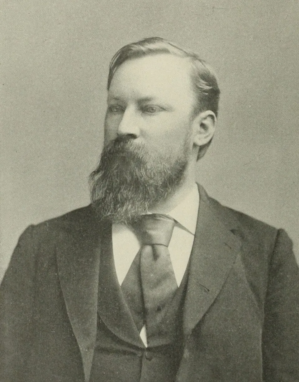 A halftone portrait of Horace Chilton: a bearded man with swept-back hair, in a dark suit and tie, looking to his right.