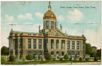 A hand-colored postcard of the Smith County Court House: a two-story stone building with a columned front and a tall dome topped by a statue.
